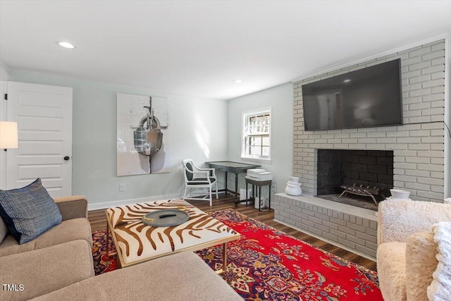 living room with recessed lighting, a fireplace, wood finished floors, and baseboards