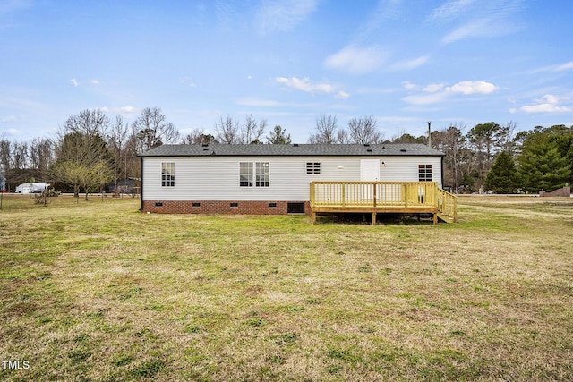 back of property with crawl space, a lawn, and a wooden deck