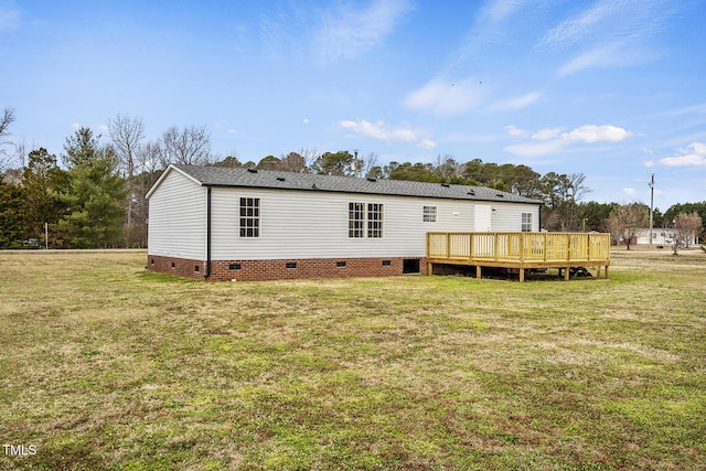 back of property with crawl space, a deck, and a lawn