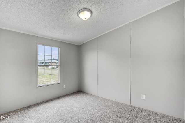 empty room with carpet floors, ornamental molding, and a textured ceiling