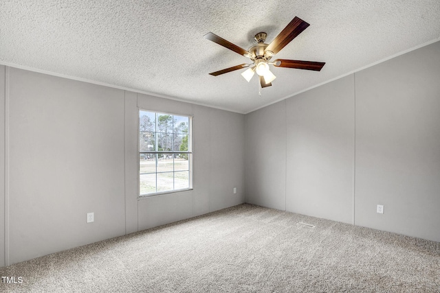 carpeted empty room with a textured ceiling, a ceiling fan, and crown molding