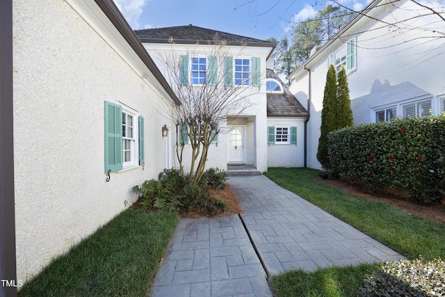 doorway to property with stucco siding