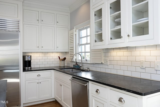 kitchen with white cabinetry, stainless steel appliances, crown molding, and a sink