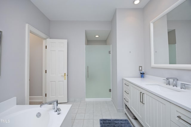 bathroom with tile patterned floors, a garden tub, a stall shower, baseboards, and vanity