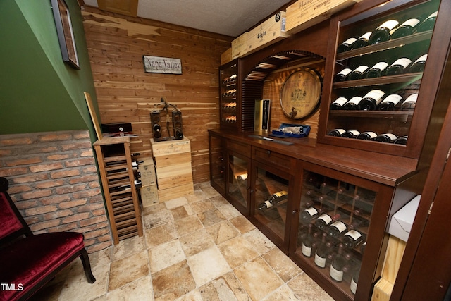 wine cellar with wooden walls and stone tile flooring