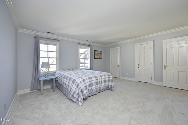 bedroom with visible vents, light colored carpet, baseboards, and ornamental molding