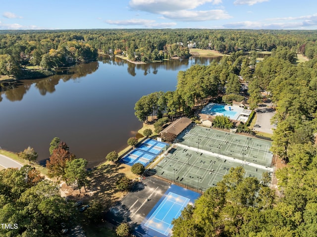 drone / aerial view with a forest view and a water view