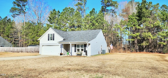 view of front of property with an attached garage, driveway, a front yard, and central air condition unit