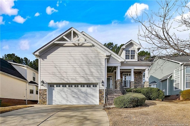 view of front of home with a porch, stone siding, an attached garage, and concrete driveway