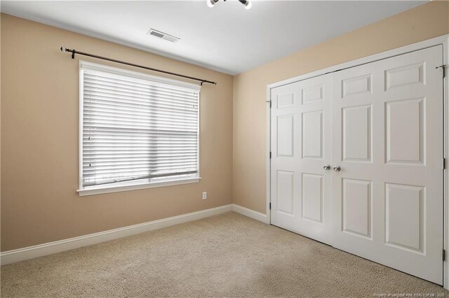 147 Lamplighter Way, Spring Lake, NC 28390 - unfurnished bedroom with visible vents, baseboards, a closet, and carpet