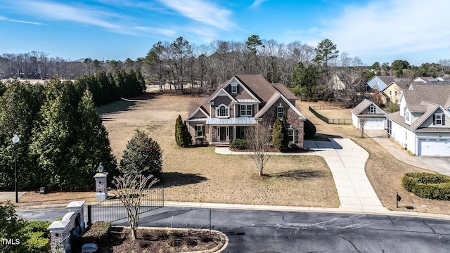 view of front of property with driveway, a front lawn, and fence