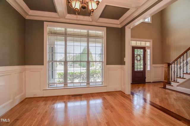 entrance foyer with light wood-style flooring, a notable chandelier, visible vents, stairway, and beam ceiling