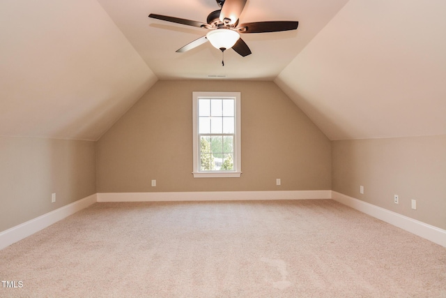 bonus room featuring carpet floors, a ceiling fan, visible vents, vaulted ceiling, and baseboards