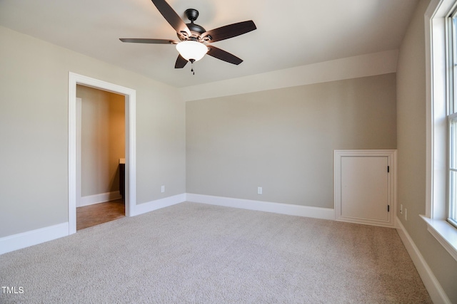 unfurnished bedroom featuring carpet floors, baseboards, and a ceiling fan