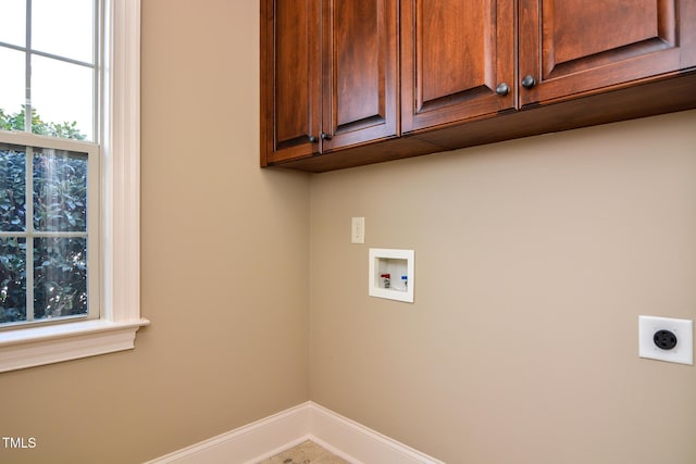 laundry room featuring hookup for a washing machine, hookup for an electric dryer, cabinet space, and baseboards