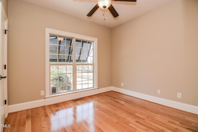 spare room featuring visible vents, light wood-style flooring, and baseboards