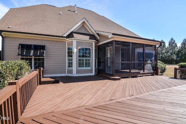 wooden deck with a sunroom