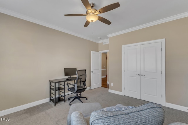 carpeted home office with a ceiling fan, baseboards, and ornamental molding