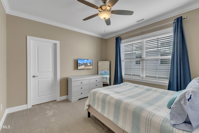 bedroom featuring visible vents, crown molding, baseboards, ceiling fan, and light colored carpet