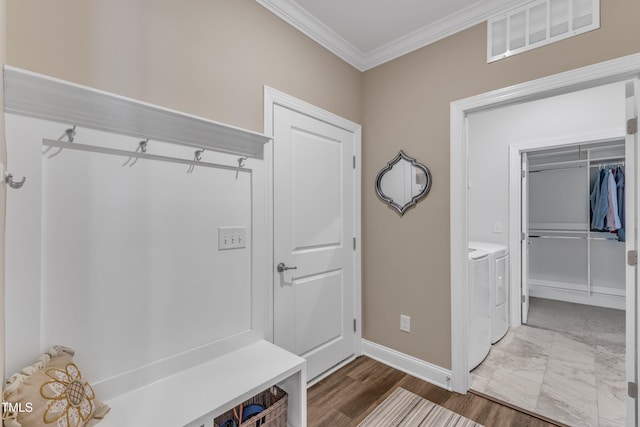 mudroom with washer and dryer, crown molding, baseboards, and visible vents