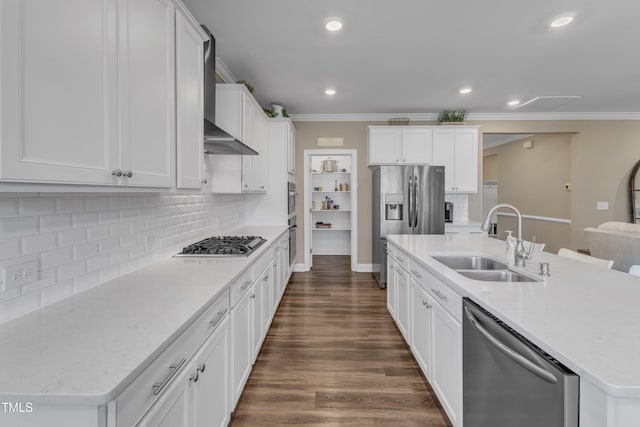 kitchen with a sink, ornamental molding, dark wood finished floors, and stainless steel appliances