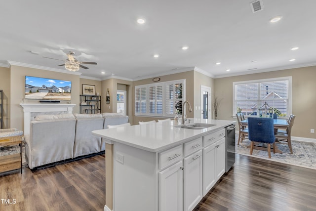 kitchen featuring ornamental molding, visible vents, dark wood-style flooring, and a sink