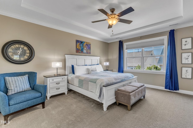 bedroom featuring a tray ceiling, carpet floors, baseboards, and visible vents