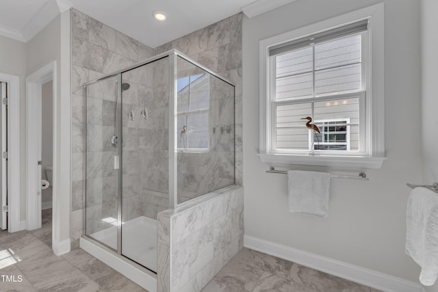 full bath featuring baseboards, toilet, marble finish floor, and a shower stall