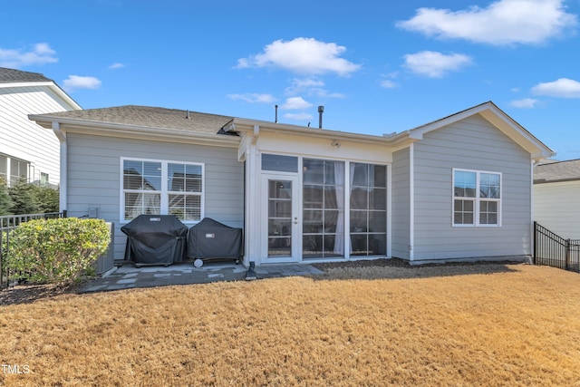 rear view of property with a patio, a yard, and fence