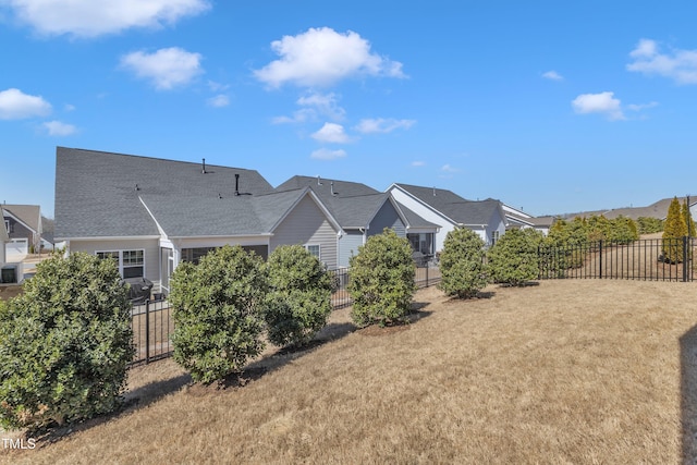 exterior space with a lawn and fence