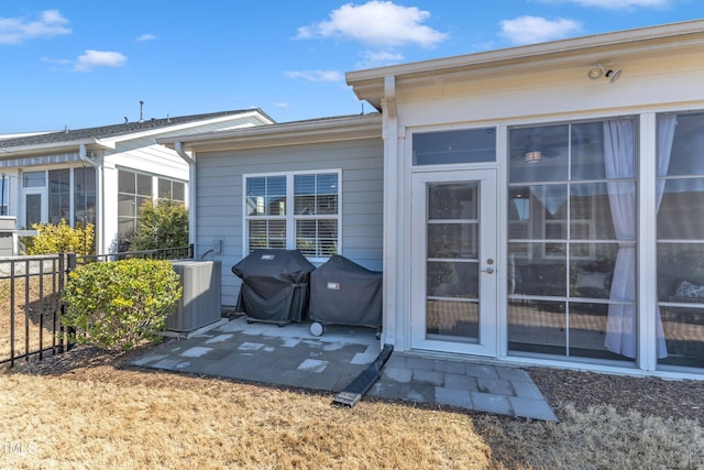 exterior space featuring central air condition unit, a patio area, and fence