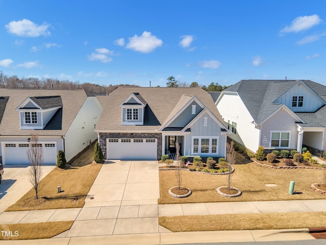 view of front facade with concrete driveway, board and batten siding, and stone siding