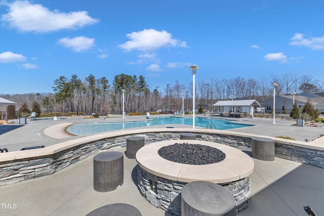 pool featuring a patio and a fire pit