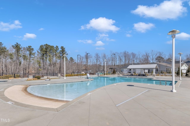 pool featuring a patio area and fence