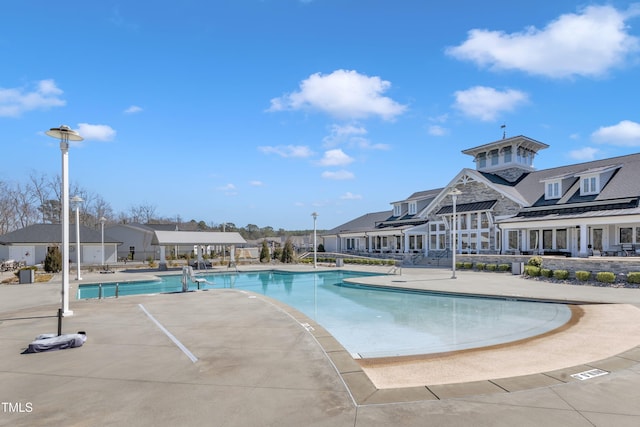 community pool featuring a patio and a residential view