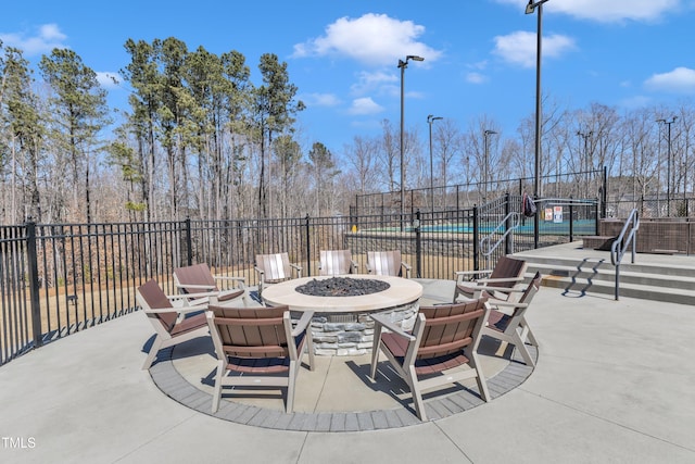 view of patio with a fire pit and fence