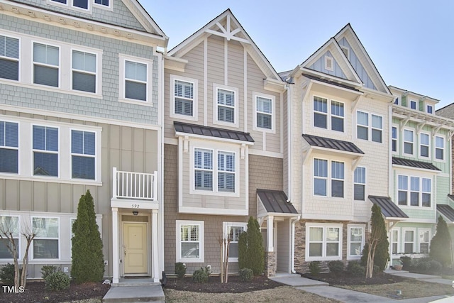 590 Grand Central Sta, Apex, NC 27502 - townhome / multi-family property with a standing seam roof, board and batten siding, a metal roof, and stone siding