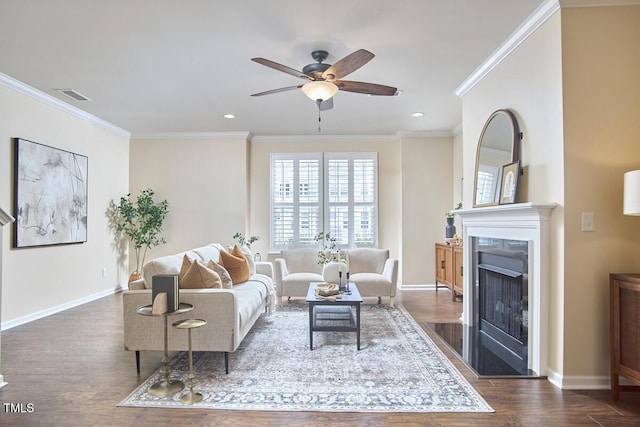 590 Grand Central Sta, Apex, NC 27502 - living area featuring dark wood-type flooring, ceiling fan, a fireplace, ornamental molding, and recessed lighting
