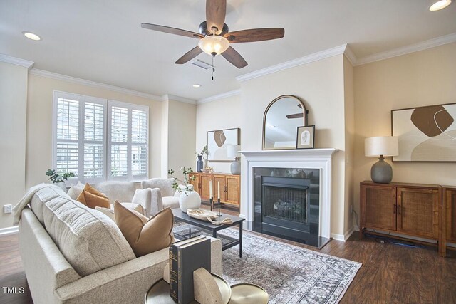 590 Grand Central Sta, Apex, NC 27502 - living area with wood finished floors, a ceiling fan, recessed lighting, ornamental molding, and a fireplace with raised hearth