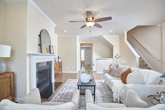590 Grand Central Sta, Apex, NC 27502 - living room with ornamental molding, wood finished floors, a ceiling fan, recessed lighting, and a fireplace with flush hearth