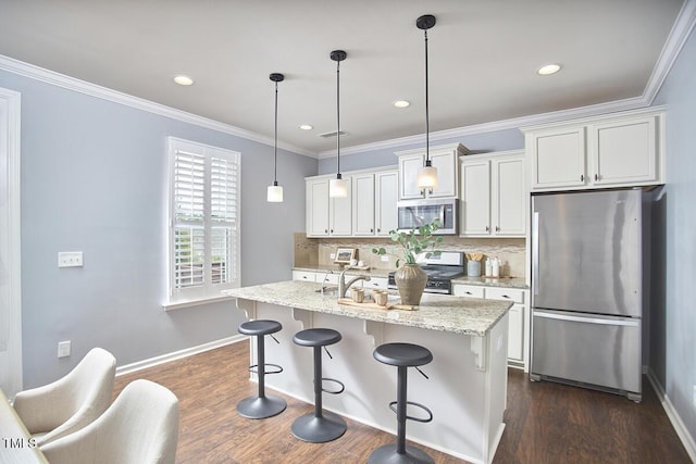 590 Grand Central Sta, Apex, NC 27502 - kitchen featuring appliances with stainless steel finishes, tasteful backsplash, a breakfast bar area, white cabinetry, and recessed lighting