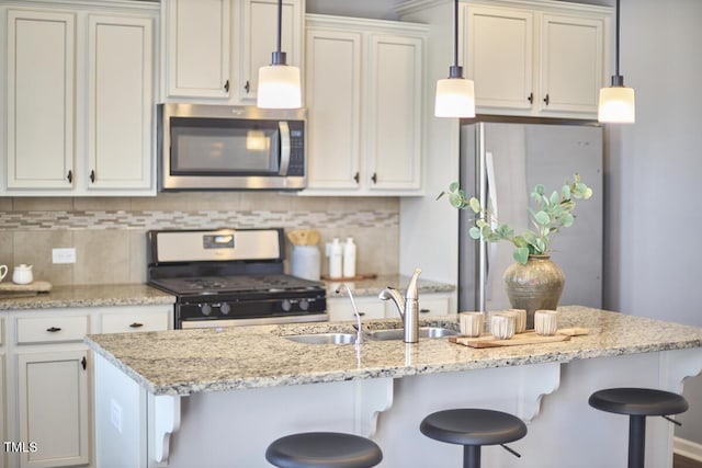 590 Grand Central Sta, Apex, NC 27502 - kitchen featuring stainless steel appliances, a kitchen breakfast bar, tasteful backsplash, decorative light fixtures, and light stone counters