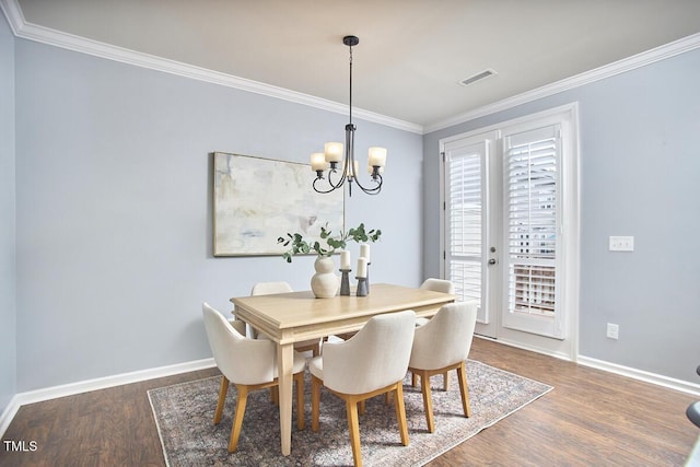 590 Grand Central Sta, Apex, NC 27502 - dining space with crown molding, wood finished floors, and a chandelier
