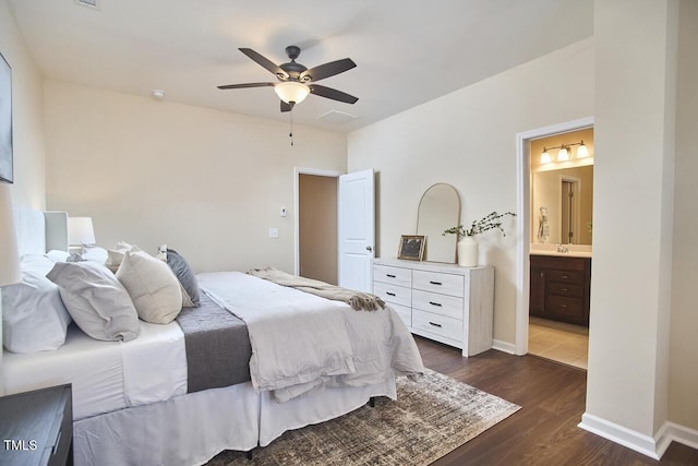 590 Grand Central Sta, Apex, NC 27502 - bedroom featuring dark wood-type flooring, ensuite bathroom, and ceiling fan