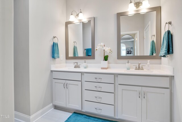 142 Oban Dr, Home, Sanford, NC 27330 - full bath with double vanity, a sink, and baseboards