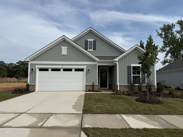 142 Oban Dr, Home, Sanford, NC 27330 - craftsman inspired home with a front lawn, a garage, driveway, board and batten siding, and brick siding