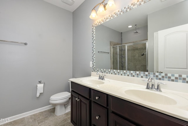 full bath with double vanity, a stall shower, a sink, and toilet