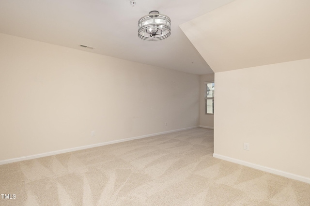 bonus room with baseboards, visible vents, and light colored carpet