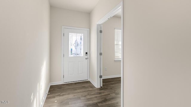 entryway featuring dark wood finished floors and baseboards