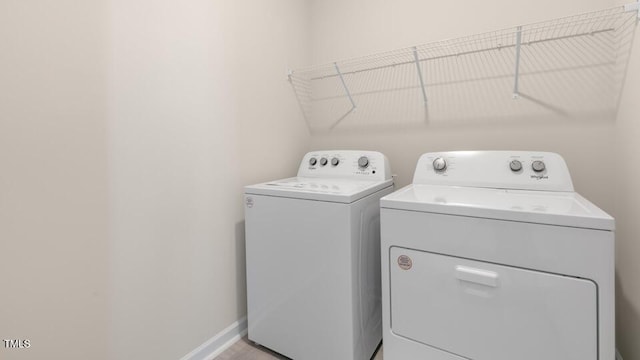 laundry area featuring laundry area, baseboards, and washer and dryer